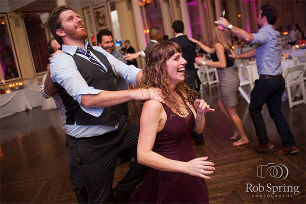 Party guests dancing at wedding  by Rob Spring Photography