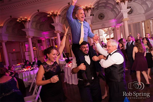 Party guests dancing at wedding  by Rob Spring Photography
