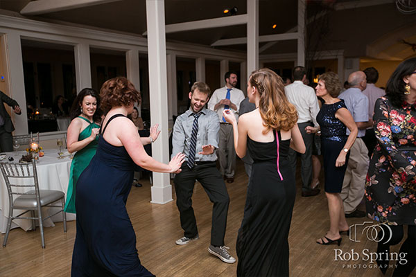 Party guests dancing on dance floor by Rob Spring Photography