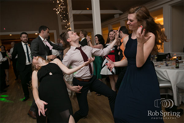Party guests dancing on dance floor by Rob Spring Photography