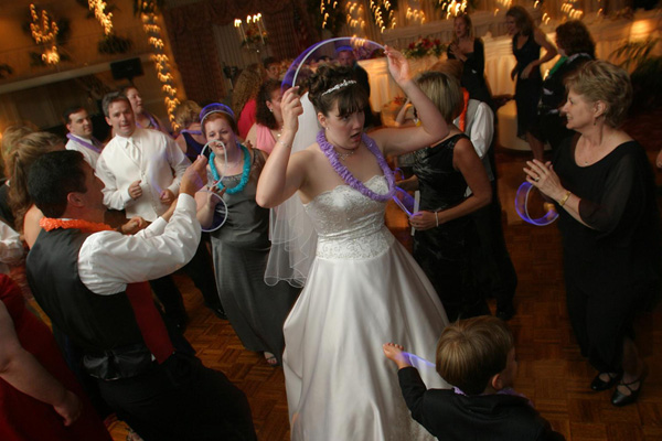 Bride dancing at wedding with glow sticks on dance floor