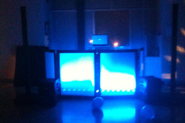 DJ booth event setup with blue up lighting