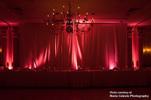 Pink up lighting for wedding reception with chandelier by Maria Celeste Photography