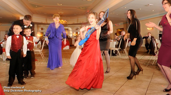 Wedding guests dancing by Skip Dickstein Photography