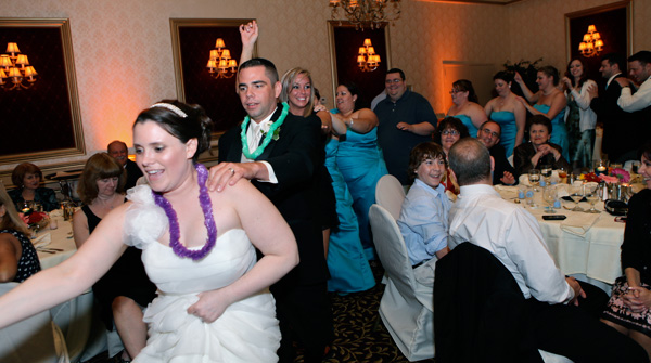 Bride, groom and wedding guests dancing