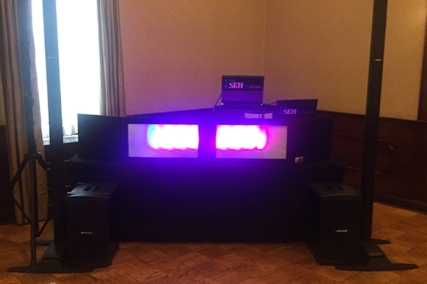 DJ booth with pink lighting for event setup