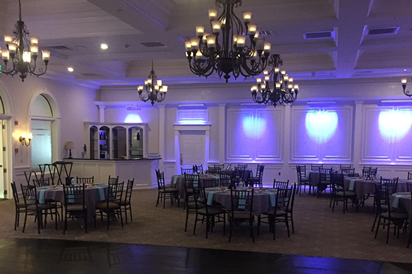 Blue up lighting at wedding reception on walls