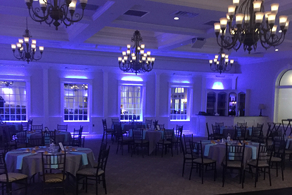 Blue up lighting on walls at wedding reception