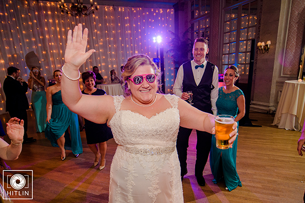 Bride dancing with sunglasses and beer