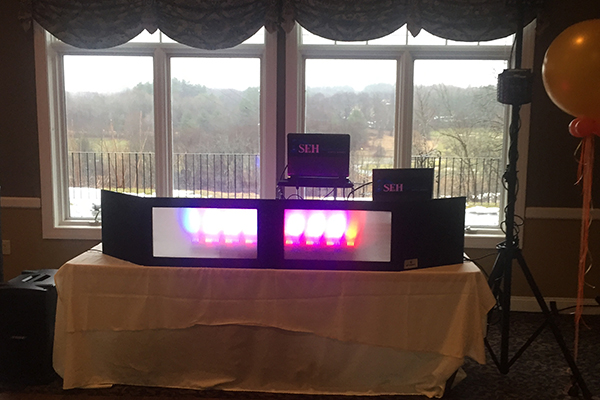 DJ booth setup with pink lights