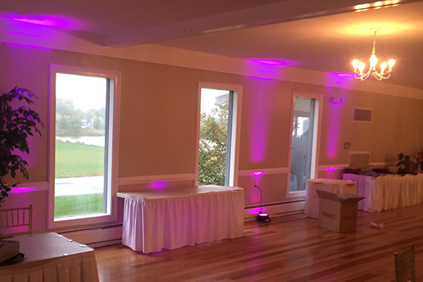Pink accent up lighting at wedding reception