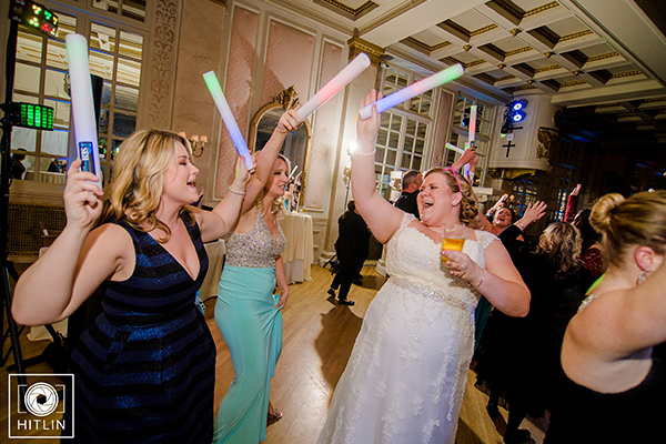 Bride dancing at wedding with friends and light up glow sticks