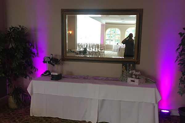 Purple up lighting at wedding reception gifts table